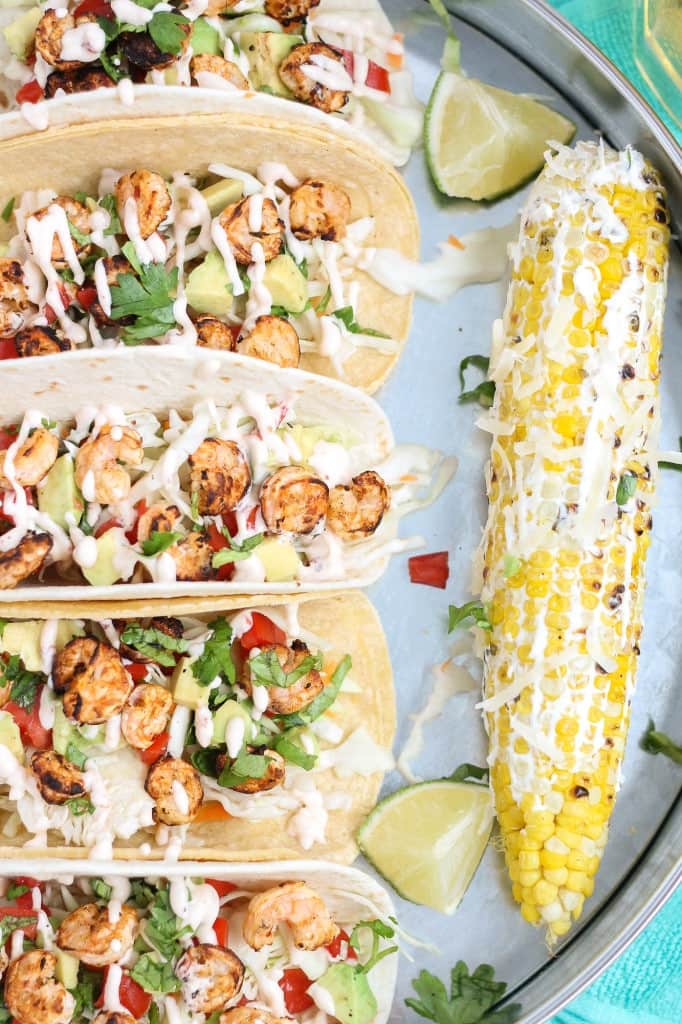 These Grilled Shrimp Tacos are deliciously easy, fun and packed with bright citrus flavor. Topped with a chipotle lime sauce and these babies are taken to a whole other level. Throw the shrimp on the grill for a delicious charred flavor and you've got yourself a quick summer meal perfect for any time of the day. | Strawberry Blondie Kitchen