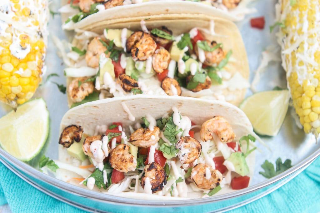 These Grilled Shrimp Tacos are deliciously easy, fun and packed with bright citrus flavor. Topped with a chipotle lime sauce and these babies are taken to a whole other level. Throw the shrimp on the grill for a delicious charred flavor and you've got yourself a quick summer meal perfect for any time of the day. | Strawberry Blondie Kitchen