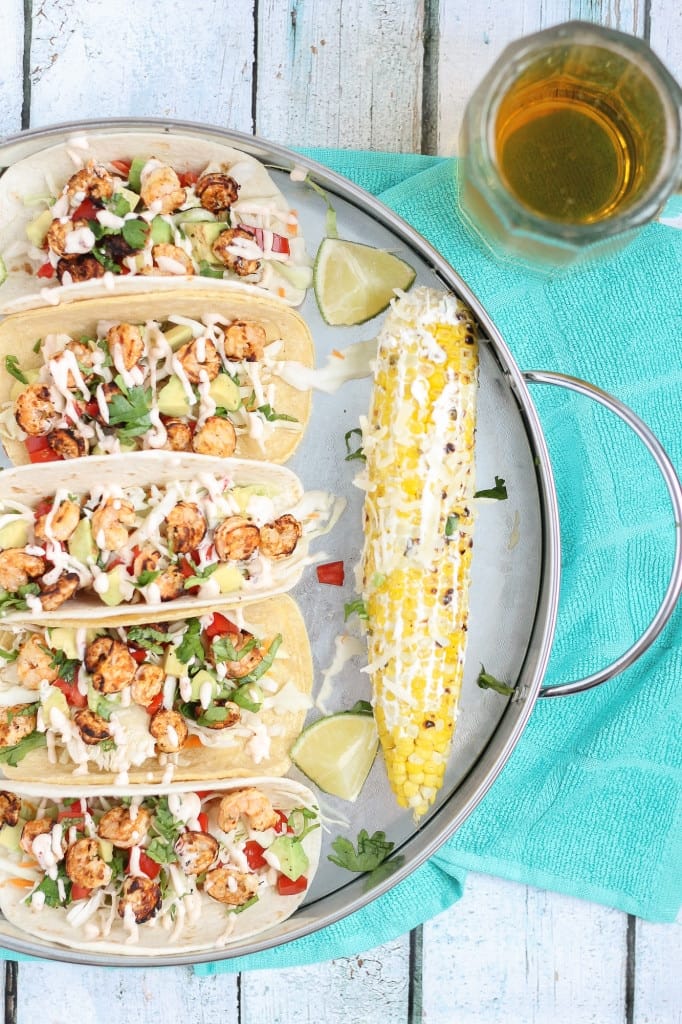 These Grilled Shrimp Tacos are deliciously easy, fun and packed with bright citrus flavor. Topped with a chipotle lime sauce and these babies are taken to a whole other level. Throw the shrimp on the grill for a delicious charred flavor and you've got yourself a quick summer meal perfect for any time of the day. | Strawberry Blondie Kitchen