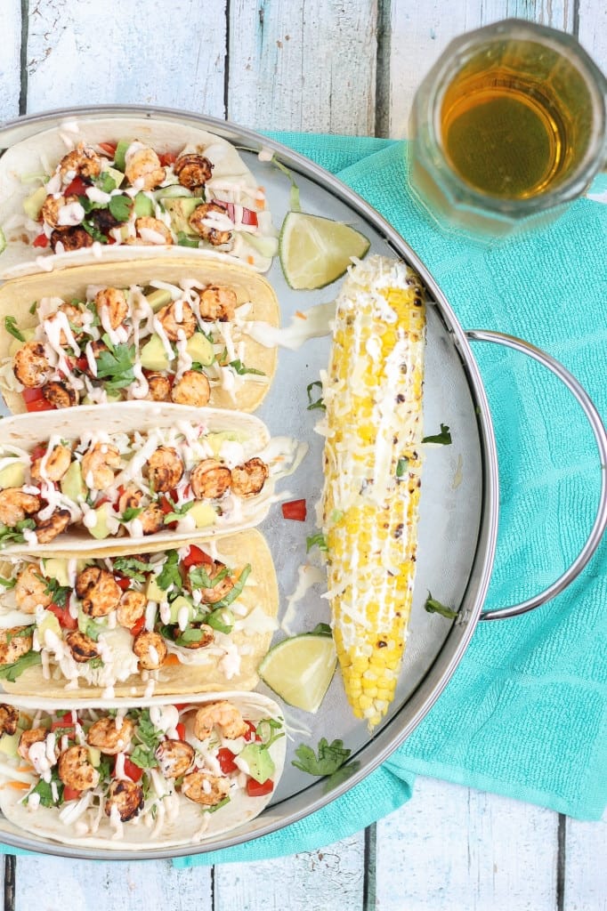 These Grilled Shrimp Tacos are deliciously easy, fun and packed with bright citrus flavor. Topped with a chipotle lime sauce and these babies are taken to a whole other level. Throw the shrimp on the grill for a delicious charred flavor and you've got yourself a quick summer meal perfect for any time of the day. | Strawberry Blondie Kitchen