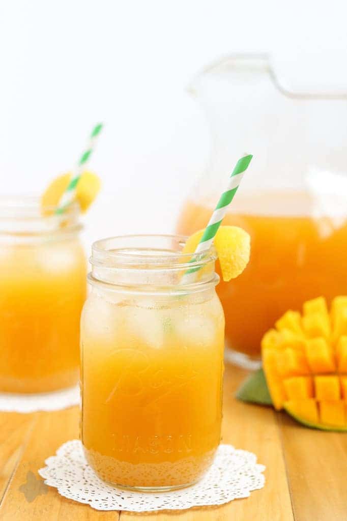 This Mango Green Tea Lemonade is the perfect thirst quencher for those long hot days of summer. Sweet mangoes pair perfectly with sour lemons and the bright taste of green tea making this drink both refreshing and addictive. | Strawberry Blondie Kitchen