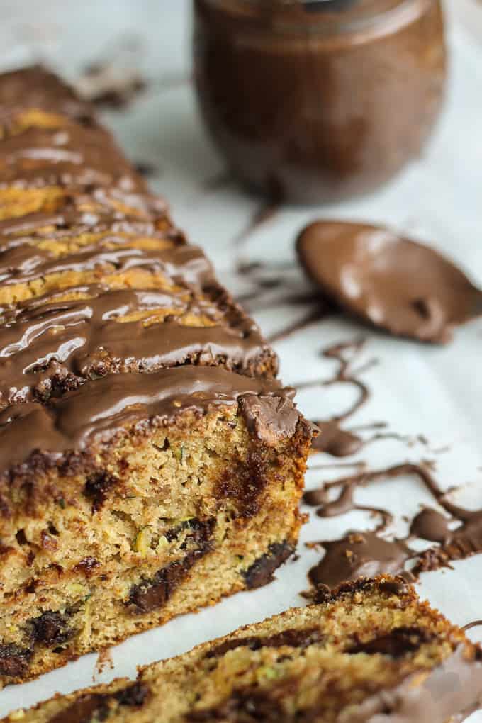 Deliciously moist, chocolaty and flavorful from warm spices such as cinnamon and nutmeg and finally drizzled with more chocolate, this Chocolate Chunk Zucchini Bread will have even the pickiest of eaters going back for a second slice! | Strawberry Blondie Kitchen