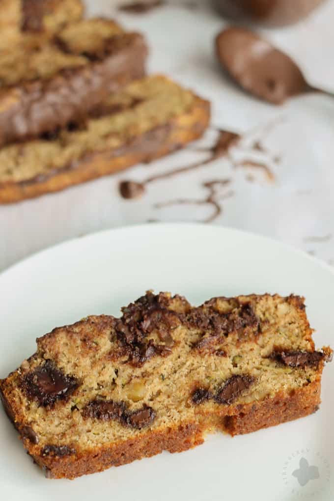Deliciously moist, chocolaty and flavorful from warm spices such as cinnamon and nutmeg and finally drizzled with more chocolate, this Chocolate Chunk Zucchini Bread will have even the pickiest of eaters going back for a second slice! | Strawberry Blondie Kitchen