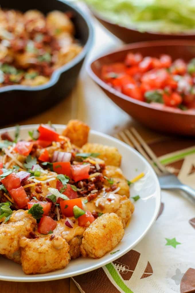 A classic twist on nachos, these Queso Fundido Totchos are a crowd pleaser. Serve them up for tailgating, an at home football party or serve them for dinner. Whatever you choose, they're sure to be a TOUCHDOWN and will have your guests going back for seconds! | Strawberry Blondie Kitchen
