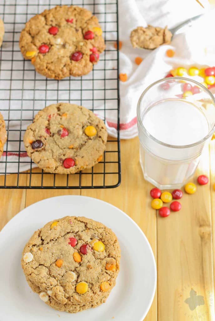 Monster cookies taken up a notch with the flavors of Autumn are both delicious and festive. Peanut butter mixed with pumpkin pie spice, white chocolate and pumpkin spice flavored chips and fall colored m & m's make these autumn monster cookies the perfect treat to serve all season long! | Strawberry Blondie Kitchen