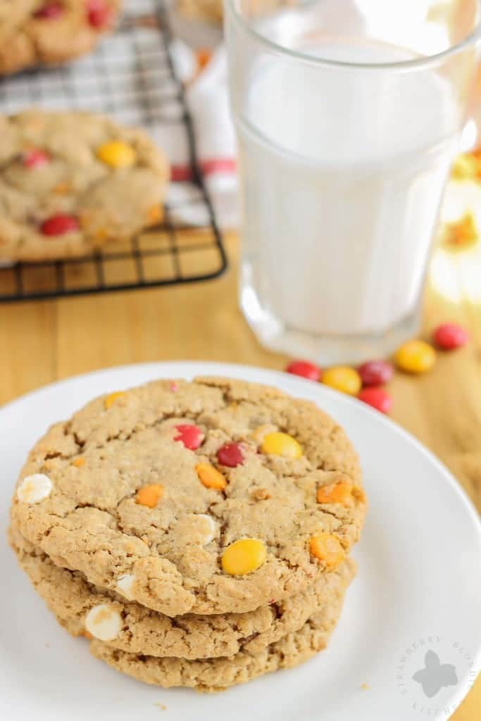 Monster cookies taken up a notch with the flavors of Autumn are both delicious and festive. Peanut butter mixed with pumpkin pie spice, white chocolate and pumpkin spice flavored chips and fall colored m & m's make these autumn monster cookies the perfect treat to serve all season long! | Strawberry Blondie Kitchen