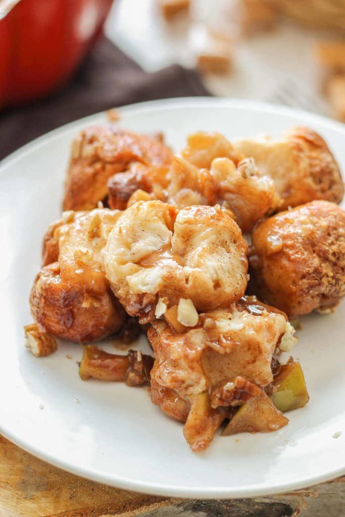 Ooey, Gooey Caramel Apple Monkey Bread is layered with sauteed apples, homemade caramel sauce, cinnamon and pecans. It's a yummy twist on classic monkey bread that'll have you never turning back. | Strawberry Blondie Kitchen