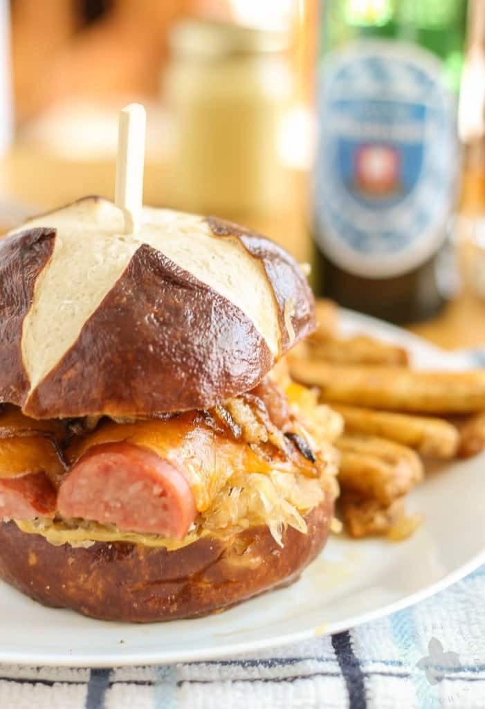 Celebrate the season with friends, merry making and this Oktoberfest Kielbasa Burger. Tangy sauerkraut topped with Hillshire Farm® Polska Kielbasa, cheddar, caramelized onions and bacon, all topped on a pretzel bun. Pair with a German beer and you've got yourself the best Oktoberfest festival west of the Atlantic! Ein Prosit! | Strawberry Blondie Kitchen