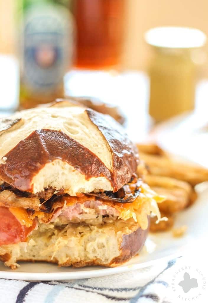Celebrate the season with friends, merry making and this Oktoberfest Kielbasa Burger. Tangy sauerkraut topped with Hillshire Farm® Polska Kielbasa, cheddar, caramelized onions and bacon, all topped on a pretzel bun. Pair with a German beer and you've got yourself the best Oktoberfest festival west of the Atlantic! Ein Prosit! | Strawberry Blondie Kitchen