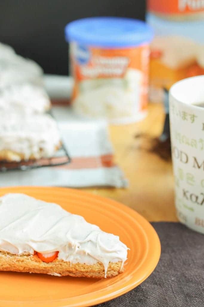 Wake up and enjoy the delicious flavors of fall with these scrumptious Pumpkin Spice Latte Scones. Made with pumpkin spice cake minx, pumpkin spice M&M's and topped with cinnamon cream cheese frosting, these are sure to start your morning off sweetly. | Strawberry Blondie Kitchen