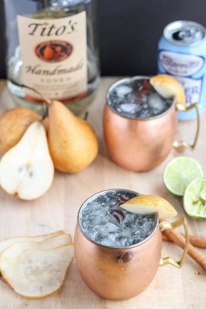 The perfect fall cocktail, this Spiced Pear Moscow Mule features spiced pear simple syrup, vodka, lime and ginger beer. It'll have you enjoying the flavors of Autumn sip after sip. | Strawberry Blondie Kitchen