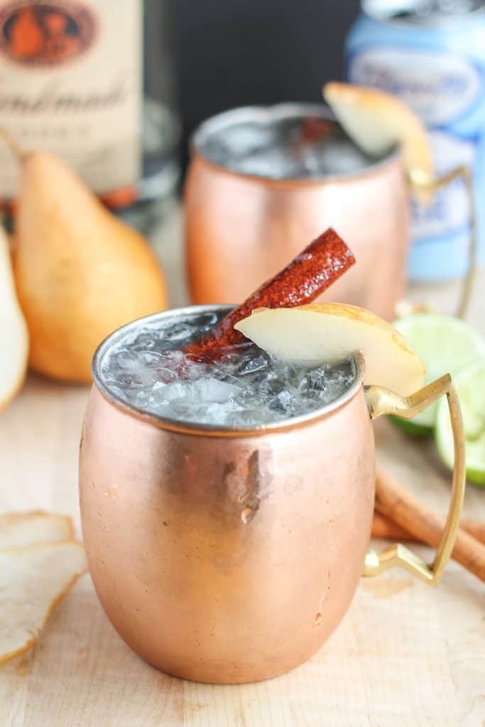 The perfect fall cocktail, this Spiced Pear Moscow Mule features spiced pear simple syrup, vodka, lime and ginger beer. It'll have you enjoying the flavors of Autumn sip after sip. | Strawberry Blondie Kitchen