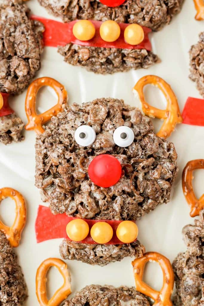 Delicious and {almost} too adorable to eat, these Rudolph the Red Nosed Reindeer Cocoa Pebbles Treats will joy and delight kids and adults alike. We can't forget about Rudolph the Red Nosed Reindeer, after all he is the one who guides Santa's sleigh. These Cocoa Pebbles treats are fun for all your holiday parties this season and they taste great too! | Strawberry Blondie Kitchen