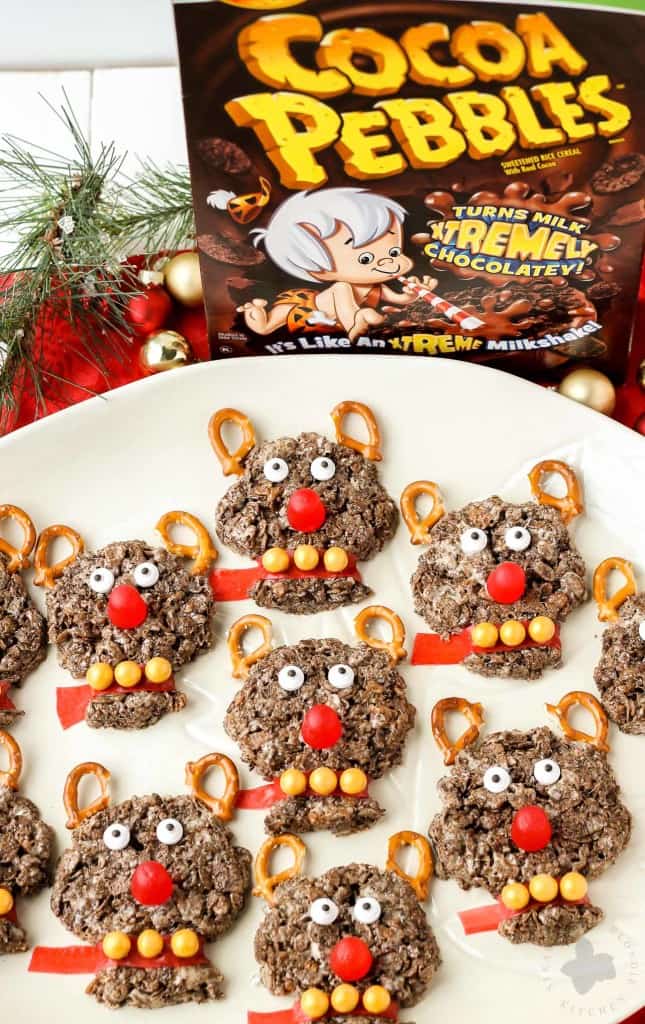 Delicious and {almost} too adorable to eat, these Rudolph the Red Nosed Reindeer Cocoa Pebbles Treats will joy and delight kids and adults alike. We can't forget about Rudolph the Red Nosed Reindeer, after all he is the one who guides Santa's sleigh. These Cocoa Pebbles treats are fun for all your holiday parties this season and they taste great too! | Strawberry Blondie Kitchen