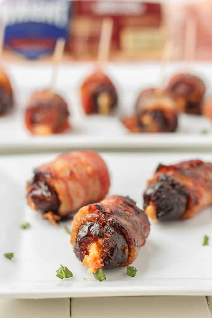 Sweet, creamy, sharp and smoky, these Bacon Wrapped Blue Cheese Stuffed Dates are perfect for your next party!  3 ingredients and super simple, these are sure to be your next go to appetizer for all those upcoming holiday festivities. | Strawberry Blondie Kitchen