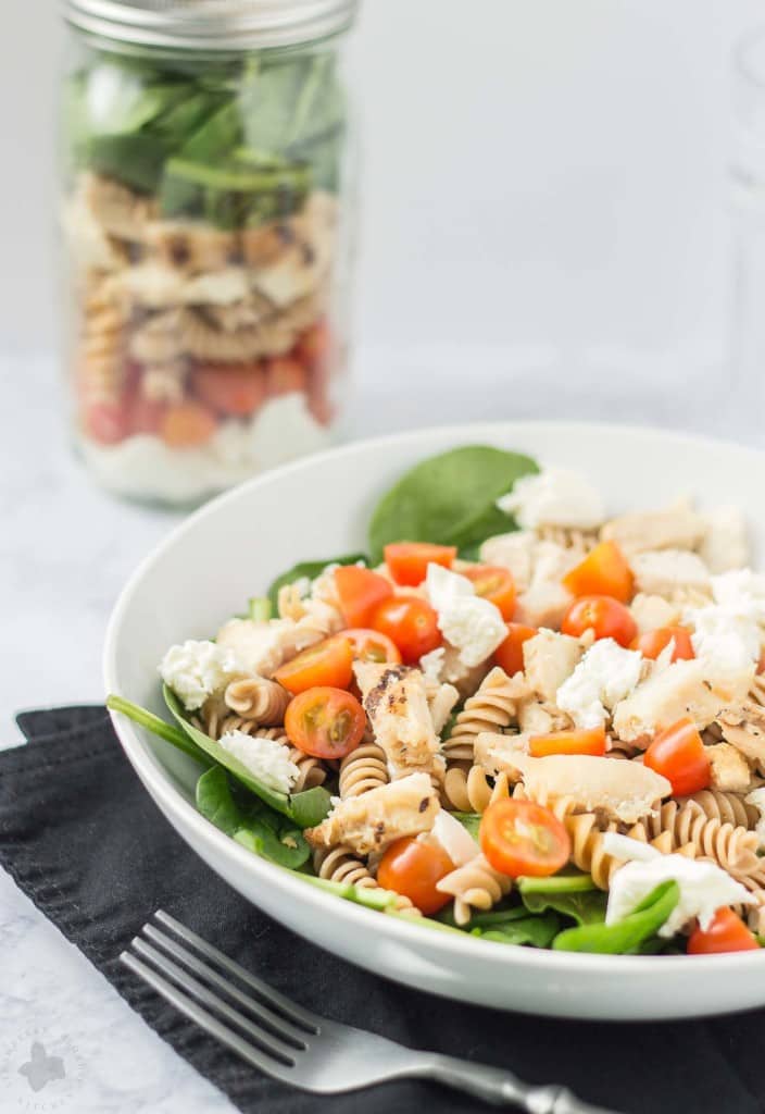 Quick and easy, healthy, portable and delicious, this Layered Chicken Caprese Salad is a meal in a jar. It can be made the night before to save time in the morning or is a perfect prep ahead dinner meal. | Strawberry Blondie Kitchen