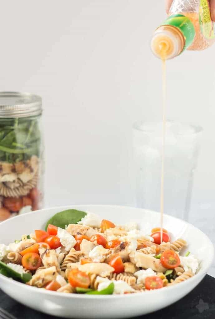 Quick and easy, healthy, portable and delicious, this Layered Chicken Caprese Salad is a meal in a jar. It can be made the night before to save time in the morning or is a perfect prep ahead dinner meal. | Strawberry Blondie Kitchen