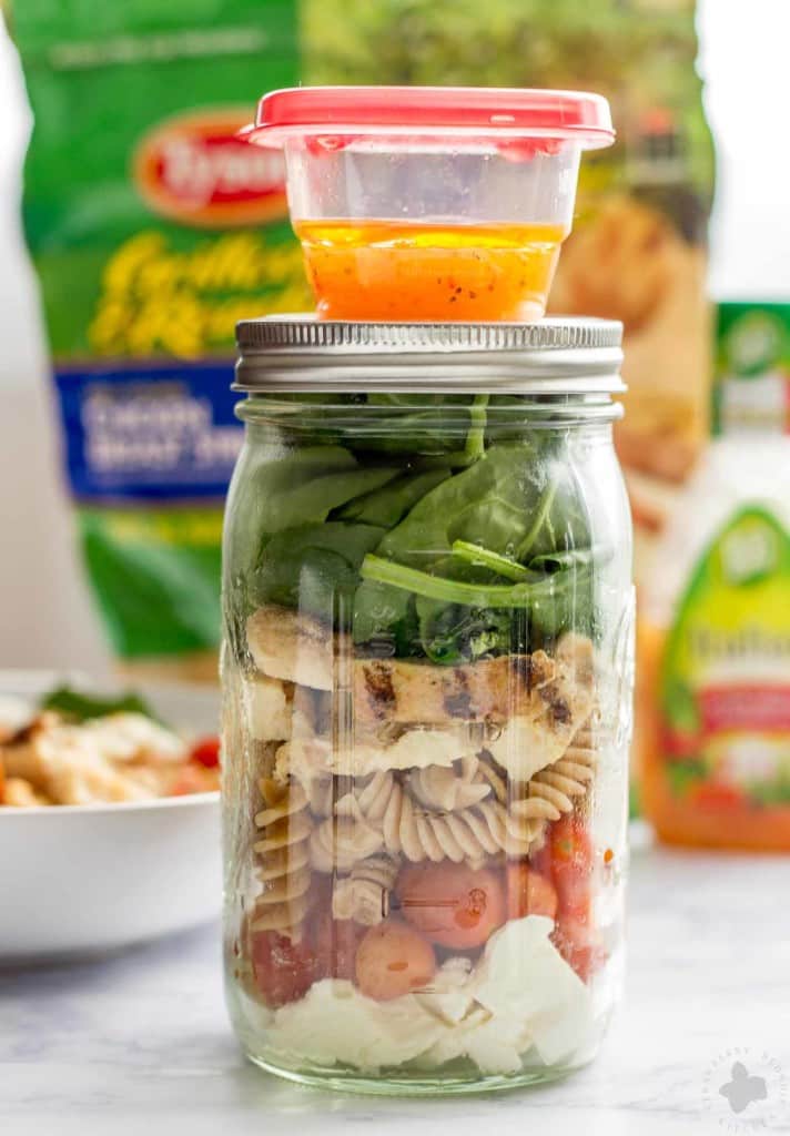 Quick and easy, healthy, portable and delicious, this Layered Chicken Caprese Salad is a meal in a jar. It can be made the night before to save time in the morning or is a perfect prep ahead dinner meal. | Strawberry Blondie Kitchen
