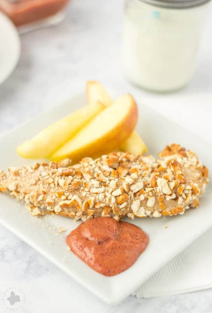 Kids starving after school and you’re tired of feeding them the same ole snack? Try these Pretzel Crusted Chicken Tenders. Chicken Tender strips are coated in Goldfish® Pretzel crackers, baked in the oven and served with a delicious Blackberry honey mustard sauce dipping sauce your kids will love! | Strawberry Blondie Kitchen