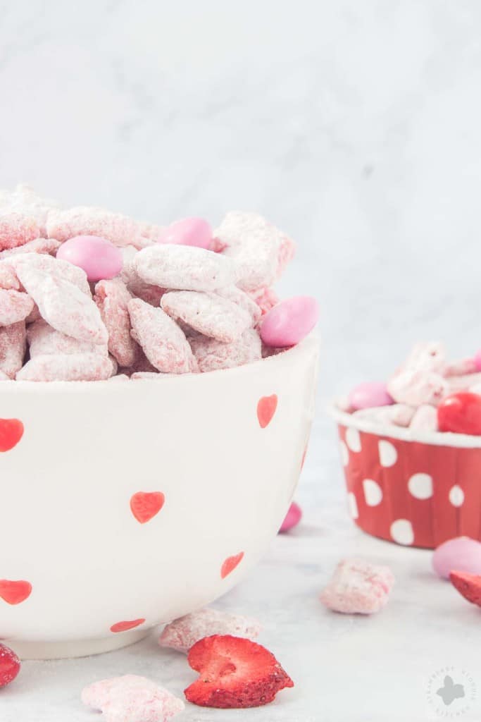 Strawberry Puppy Chow is deliciously sweet, crunchy and highly addictive. A tasty and sweet snack your sweetheart is sure to love! | Strawberry Blondie Kitchen