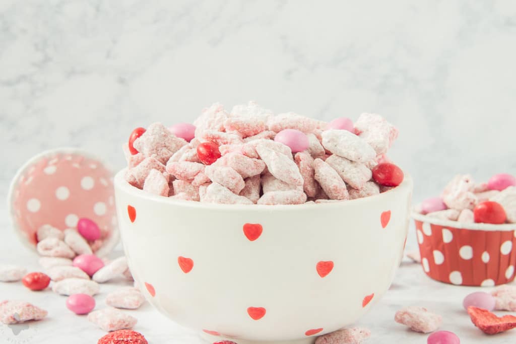 Strawberry Puppy Chow is deliciously sweet, crunchy and highly addictive. A tasty and sweet snack your sweetheart is sure to love!