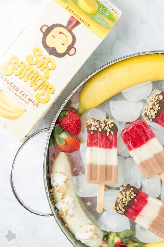 Layers of fresh strawberries, Sir BananamilkTM, and Sir Chocolate BananamilkTM make these Banana Split Popsicles irresistible to both adults and children alike. | Strawberry Blondie Kitchen