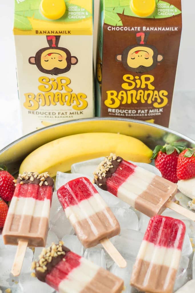 Layers of fresh strawberries, Sir BananamilkTM, and Sir Chocolate BananamilkTM make these Banana Split Popsicles irresistible to both adults and children alike. | Strawberry Blondie Kitchen