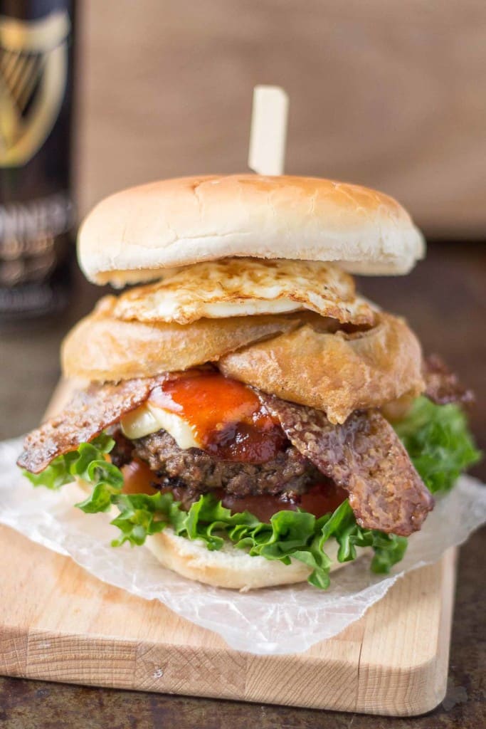 An All American beef patty with Guinness Battered Onion rings, Jameson BBQ sauce and Candied Baileys Bacon, this Irish Car Bomb Burger is literally a flavor bomb! | Strawberry Blondie Kitchen