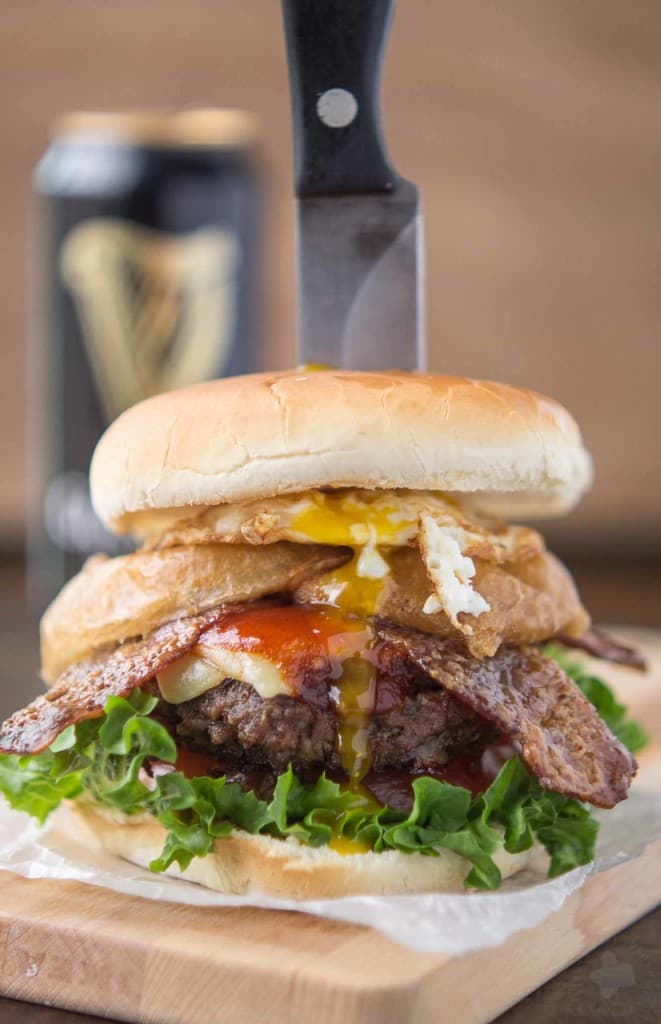 An All American beef patty with Guinness Battered Onion rings, Jameson BBQ sauce and Candied Baileys Bacon, this Irish Car Bomb Burger is literally a flavor bomb! | Strawberry Blondie Kitchen