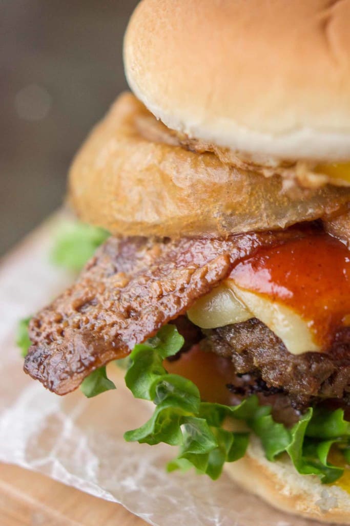 An All American beef patty with Guinness Battered Onion rings, Jameson BBQ sauce and Candied Baileys Bacon, this Irish Car Bomb Burger is literally a flavor bomb! | Strawberry Blondie Kitchen