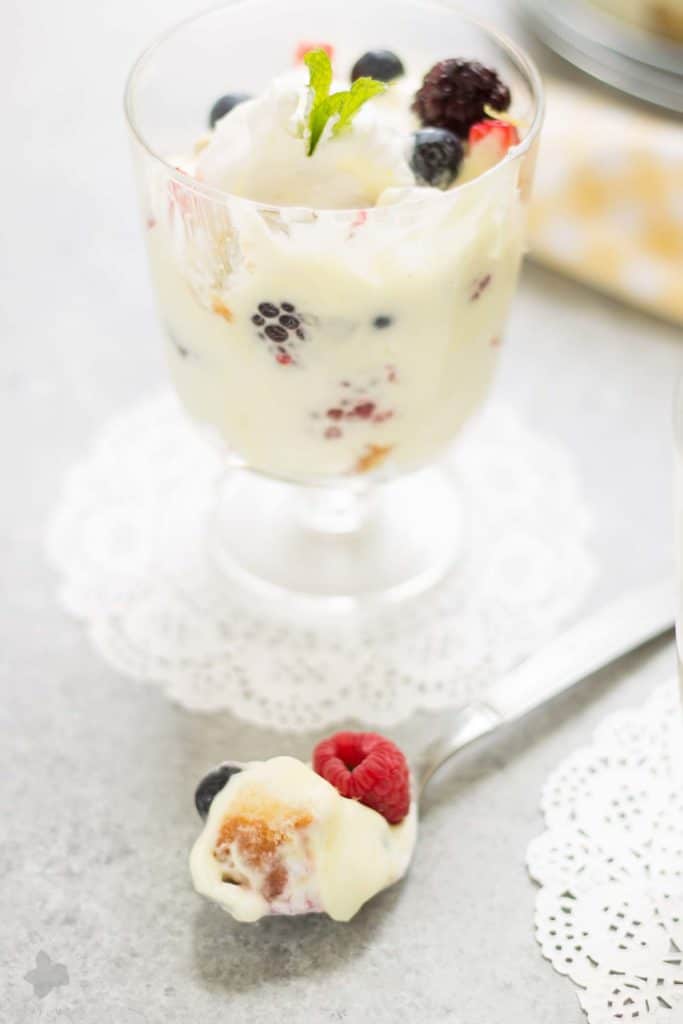 Celebrate the bountiful berries of the season with this Lemon Berry Trifle. Strawberries, blueberries, raspberries and blackberries are layered between tart lemon pudding, whipped cream and studded with delicious pound cake. The perfect summer dessert for all your backyard parties! | Strawberry Blondie Kitchen