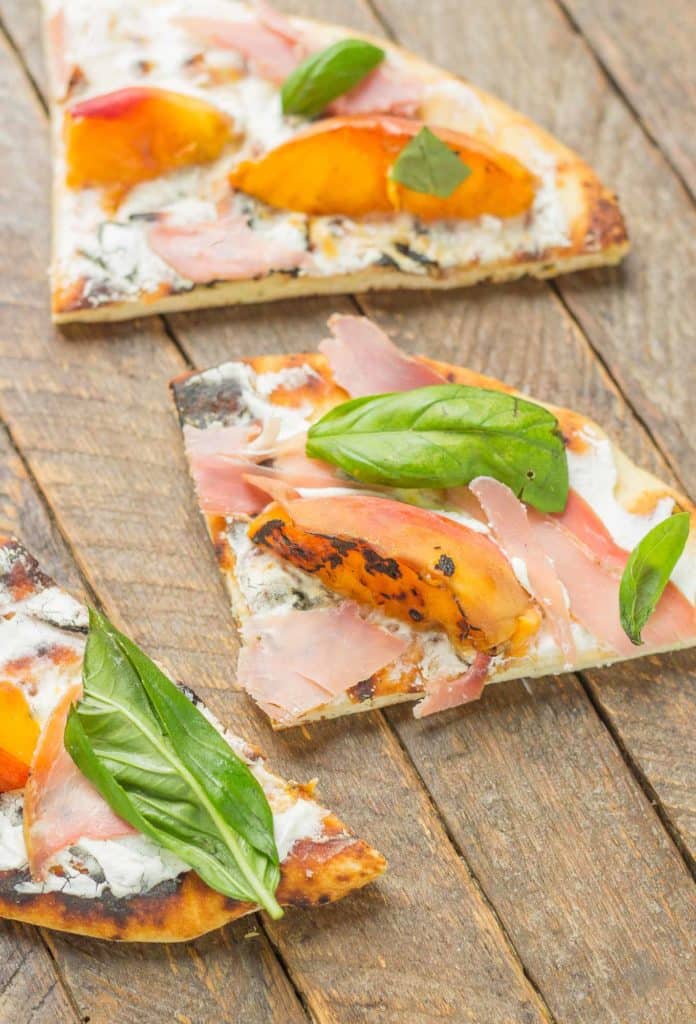 Tender and sweet peaches are a match made in Heaven with salty prosciutto, tangy, creamy goat cheese all piled high on garlic naan bread. This Grilled Peach, Prosciutto and Goat Cheese Pizza will have your taste buds singing the sweet and savory tunes of summer | Strawberry Blondie Kitchen