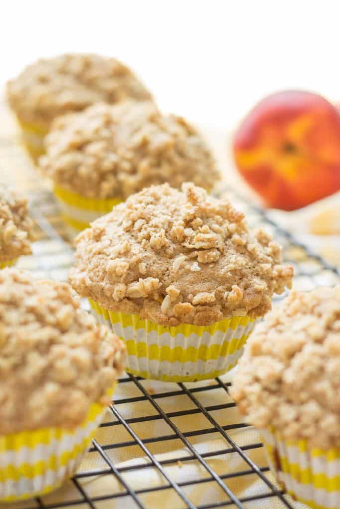 Start your morning with these delicious Peach Oatmeal Crumb Muffins. They're super moist and tender, studded with sweet, juicy peaches and are overflowing with an irresistible oatmeal crumb topping. These just might be your next favorite muffin recipe and for good reason! | Strawberry Blondie Kitchen