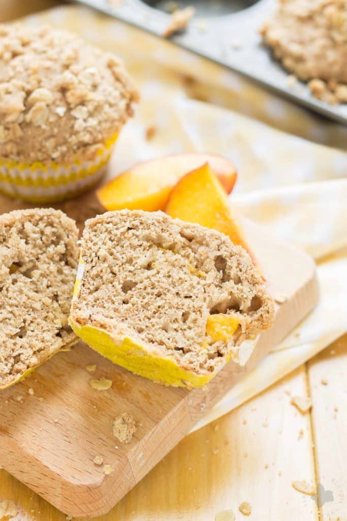 Start your morning with these delicious Peach Oatmeal Crumb Muffins. They're super moist and tender, studded with sweet, juicy peaches and are overflowing with an irresistible oatmeal crumb topping. These just might be your next favorite muffin recipe and for good reason! | Strawberry Blondie Kitchen