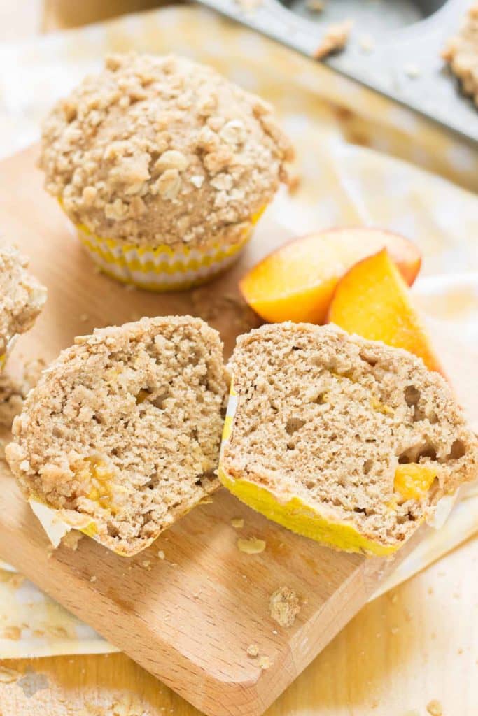 Start your morning with these delicious Peach Oatmeal Crumb Muffins. They're super moist and tender, studded with sweet, juicy peaches and are overflowing with an irresistible oatmeal crumb topping. These just might be your next favorite muffin recipe and for good reason! | Strawberry Blondie Kitchen