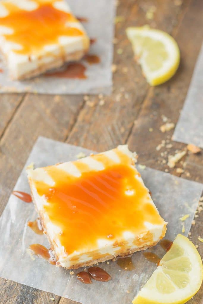 Tangy, tart lemon cheesecake bars are topped with a sweet tea caramel sauce to perfectly marry the two together and create Arnold Palmer Cheesecake Bars. Your favorite way to quench your thirst is now in dessert form! | Strawberry Blondie Kitchen