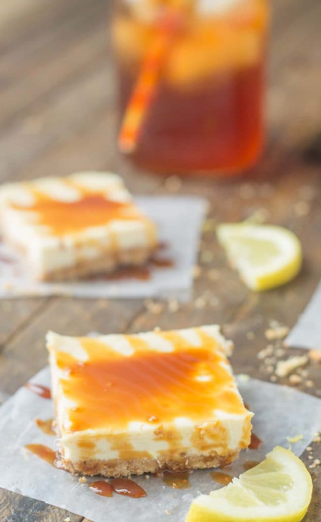 Tangy, tart lemon cheesecake bars are topped with a sweet tea caramel sauce to perfectly marry the two together and create Arnold Palmer Cheesecake Bars. Your favorite way to quench your thirst is now in dessert form! | Strawberry Blondie Kitchen