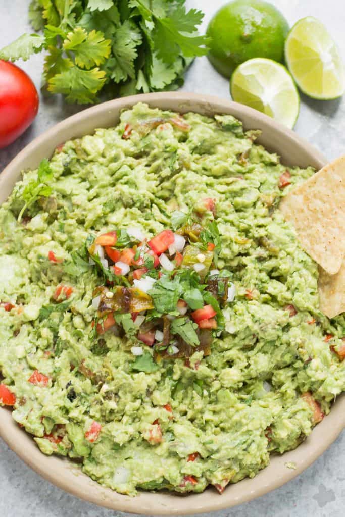 Add a little heat and smokiness to your guacamole with fire roasted hatch chiles. Only in season for a short time, so get your hands on some of these babies and make this delicious, crowd pleasing Hatch Chile Guacamole. | Strawberry Blondie Kitchen