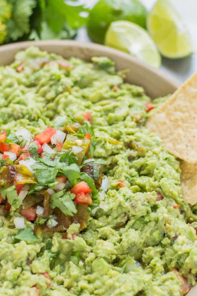 Add a little heat and smokiness to your guacamole with fire roasted hatch chiles. Only in season for a short time, so get your hands on some of these babies and make this delicious, crowd pleasing Hatch Chile Guacamole. | Strawberry Blondie Kitchen