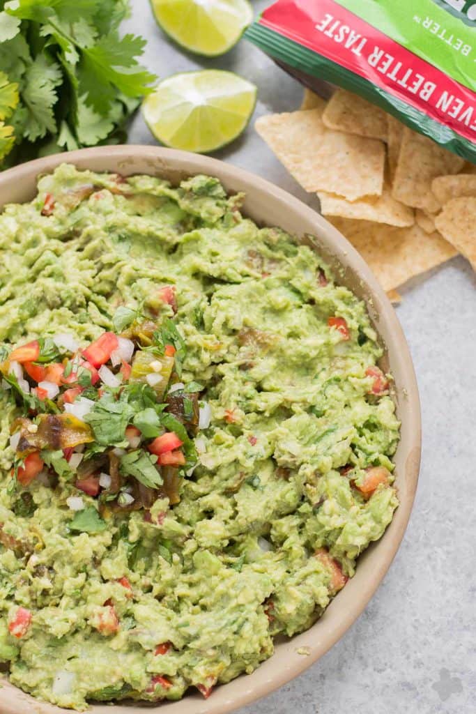 Add a little heat and smokiness to your guacamole with fire roasted hatch chiles. Only in season for a short time, so get your hands on some of these babies and make this delicious, crowd pleasing Hatch Chile Guacamole. | Strawberry Blondie Kitchen