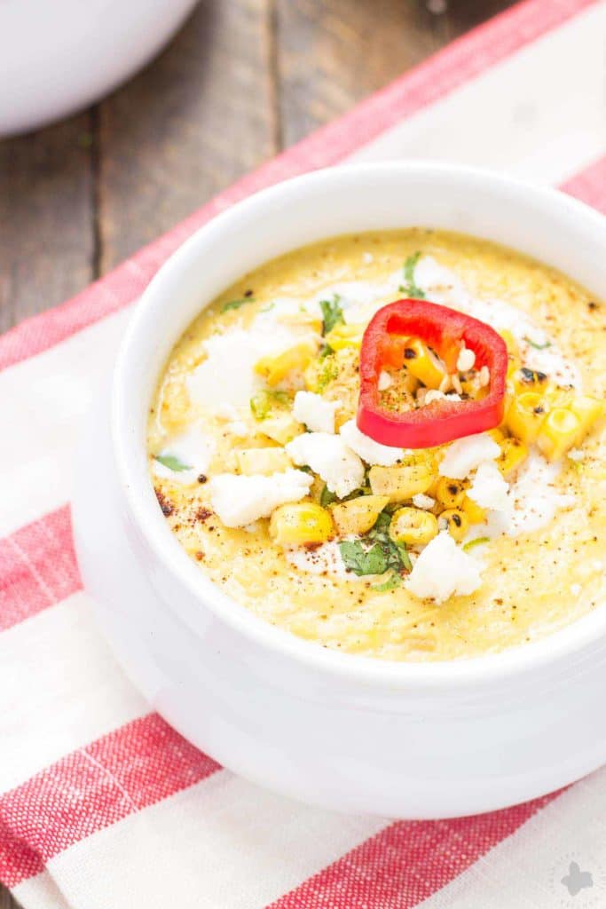 Combine all the flavors you love of Mexican Street Corn and blend them into a delicious summer soup. Sweet corn, lime, chili powder and cheese meld together beautifully to make this luscious and creamy Mexican Street Corn Chowder. | Strawberry Blondie Kitchen