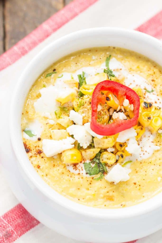 Combine all the flavors you love of Mexican Street Corn and blend them into a delicious summer soup. Sweet corn, lime, chili powder and cheese meld together beautifully to make this luscious and creamy Mexican Street Corn Chowder. | Strawberry Blondie Kitchen