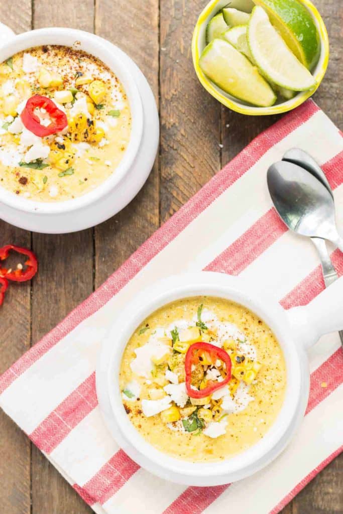 Combine all the flavors you love of Mexican Street Corn and blend them into a delicious summer soup. Sweet corn, lime, chili powder and cheese meld together beautifully to make this luscious and creamy Mexican Street Corn Chowder. | Strawberry Blondie Kitchen