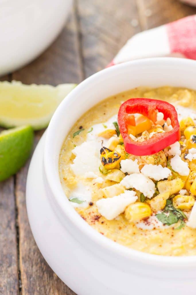 Combine all the flavors you love of Mexican Street Corn and blend them into a delicious summer soup. Sweet corn, lime, chili powder and cheese meld together beautifully to make this luscious and creamy Mexican Street Corn Chowder. | Strawberry Blondie Kitchen