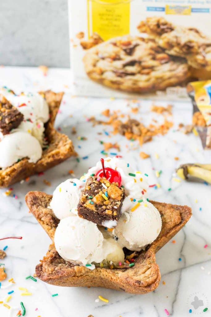 Freshly baked chocolate chip cookies are molded into bowls and piled high with all your favorite ice cream sundae favorites. Now you can have your ice cream and eat the bowl too! The Ultimate Ice Cream Sundae Bowl are an ice cream lovers dream. | Strawberry Blondie Kitchen