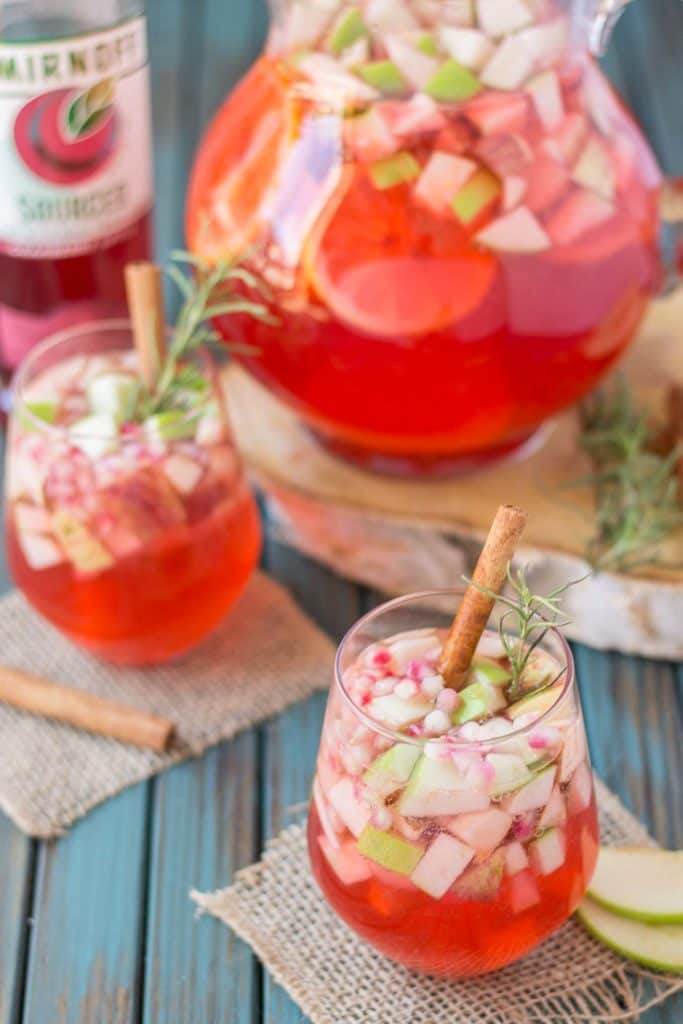 A delicious blend of cranberries, apples, cinnamon, rosemary and seasonal fruits make this Cranberry Apple Rosemary Sangria the go to cocktail of Autumn. | Strawberry Blondie Kitchen