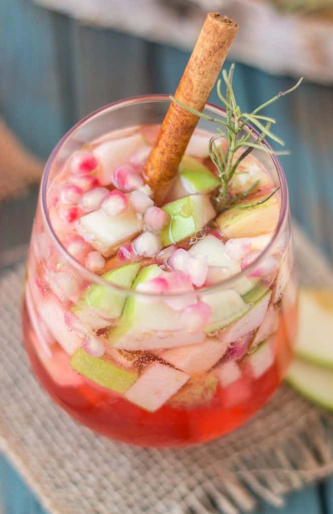 A delicious blend of cranberries, apples, cinnamon, rosemary and seasonal fruits make this Cranberry Apple Rosemary Sangria the go to cocktail of Autumn. | Strawberry Blondie Kitchen