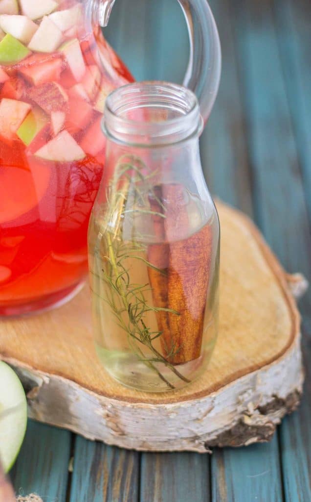 A delicious blend of cranberries, apples, cinnamon, rosemary and seasonal fruits make this Cranberry Apple Rosemary Sangria the go to cocktail of Autumn. | Strawberry Blondie Kitchen