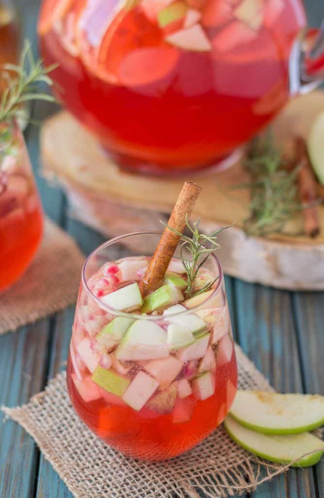 A delicious blend of cranberries, apples, cinnamon, rosemary and seasonal fruits make this Cranberry Apple Rosemary Sangria the go to cocktail of Autumn. | Strawberry Blondie Kitchen