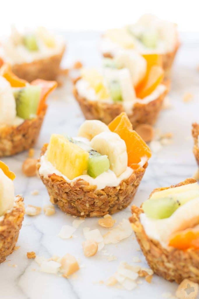 Head to the islands with these Tropical Granola Cups. These cups are made with Honey Bunches of Oats® cereal, bananas, oatmeal and coconut. Then filled with yogurt and delicious tropical fruits. You'll feel like you're on an island oasis every morning! | Strawberry Blondie Kitchen